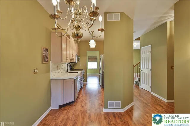 a view of kitchen with granite countertop cabinets and sink