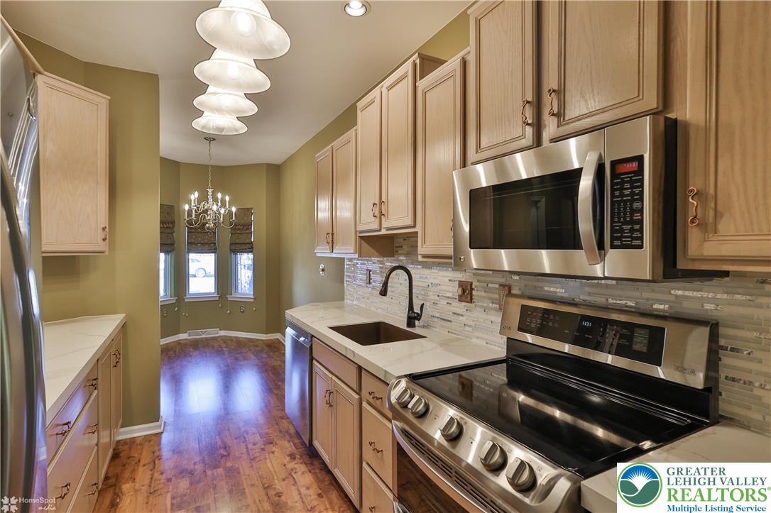 1302 Adams Street Northampton, PA 18067 - Photo 9 of 57 a kitchen with stainless steel appliances granite countertop a stove and a microwave