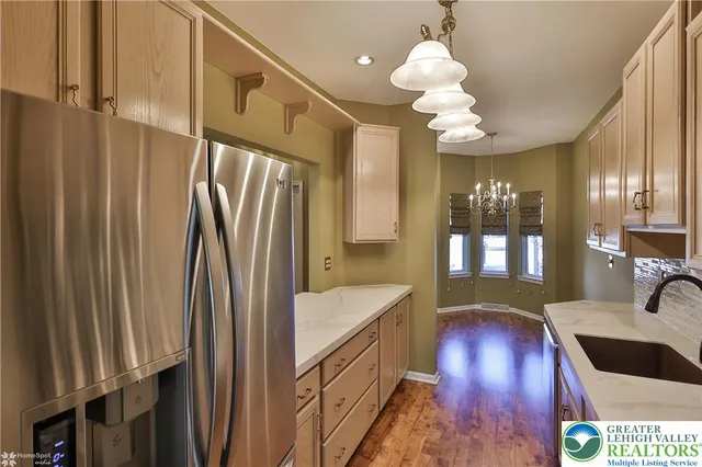 a bathroom with a sink a large mirror and vanity