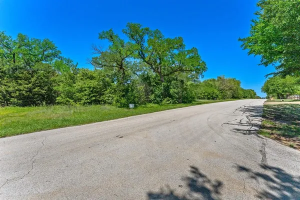 a view of a road with a yard