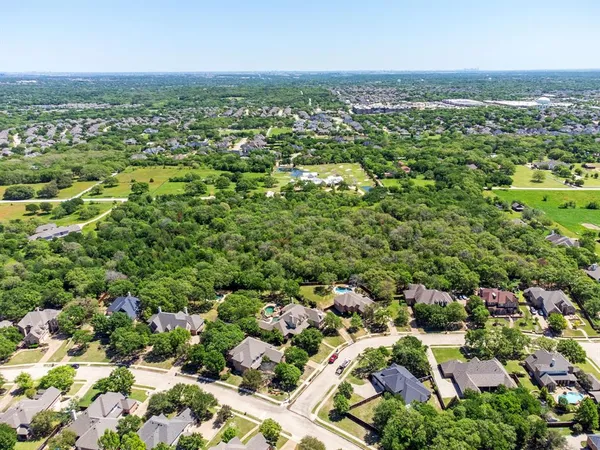 an aerial view of residential houses with city view