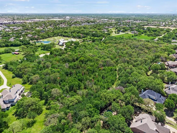 a view of a city with lush green forest