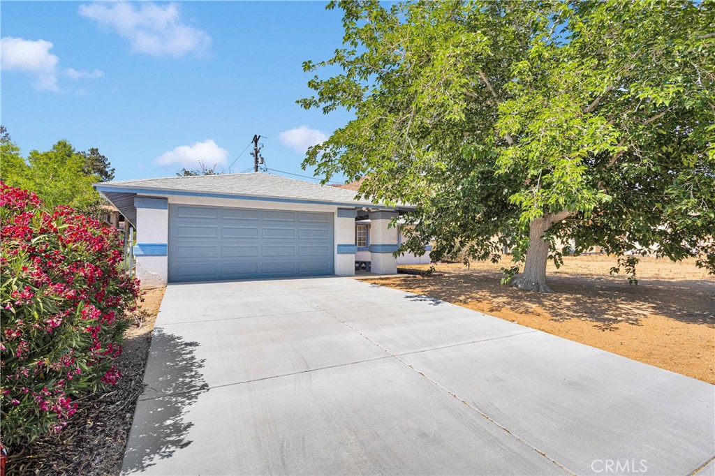 23870 Guajome Road Apple Valley, CA 92307 - Photo 1 of 1 a front view of a house with a yard and garage