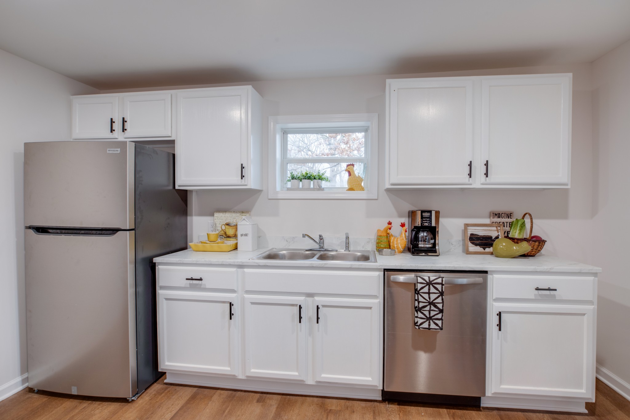 324 Cowan Road Dickson, TN 37055 - Photo 5 of 18 a kitchen with stainless steel appliances a sink a refrigerator and cabinets