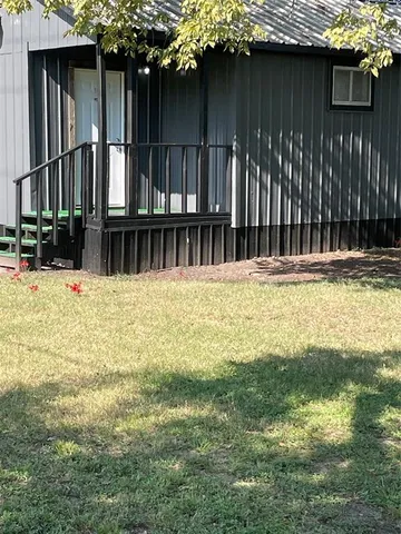 a view of a house with a small yard