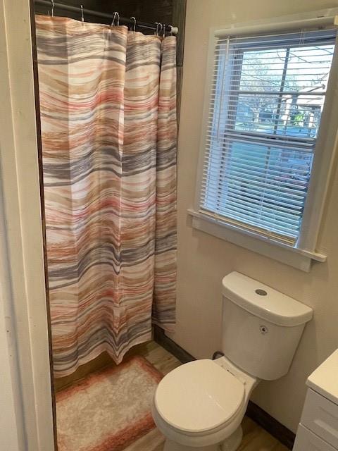 311 Southwest 6th Street Kerens, TX 75144 - Photo 17 of 24 a bathroom with a toilet and a shower curtain
