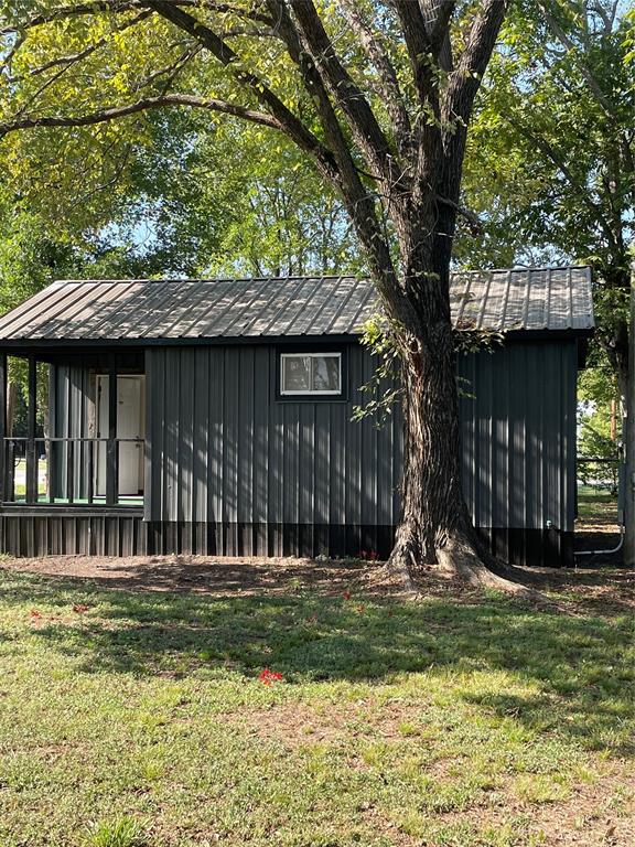 311 Southwest 6th Street Kerens, TX 75144 - Photo 6 of 24 a front view of a house with a garden