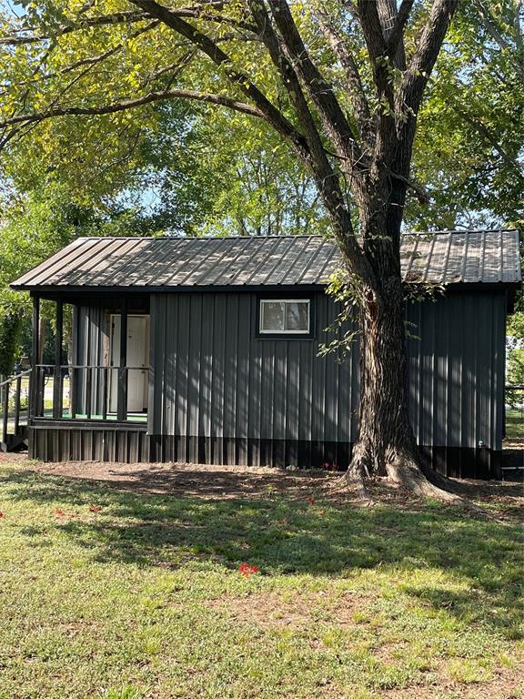311 Southwest 6th Street Kerens, TX 75144 - Photo 7 of 24 a front view of a house with a garden