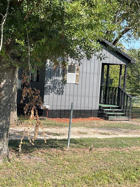 311 Southwest 6th Street Kerens, TX 75144 - Photo 10 of 24 a view of a house with a small yard and large tree