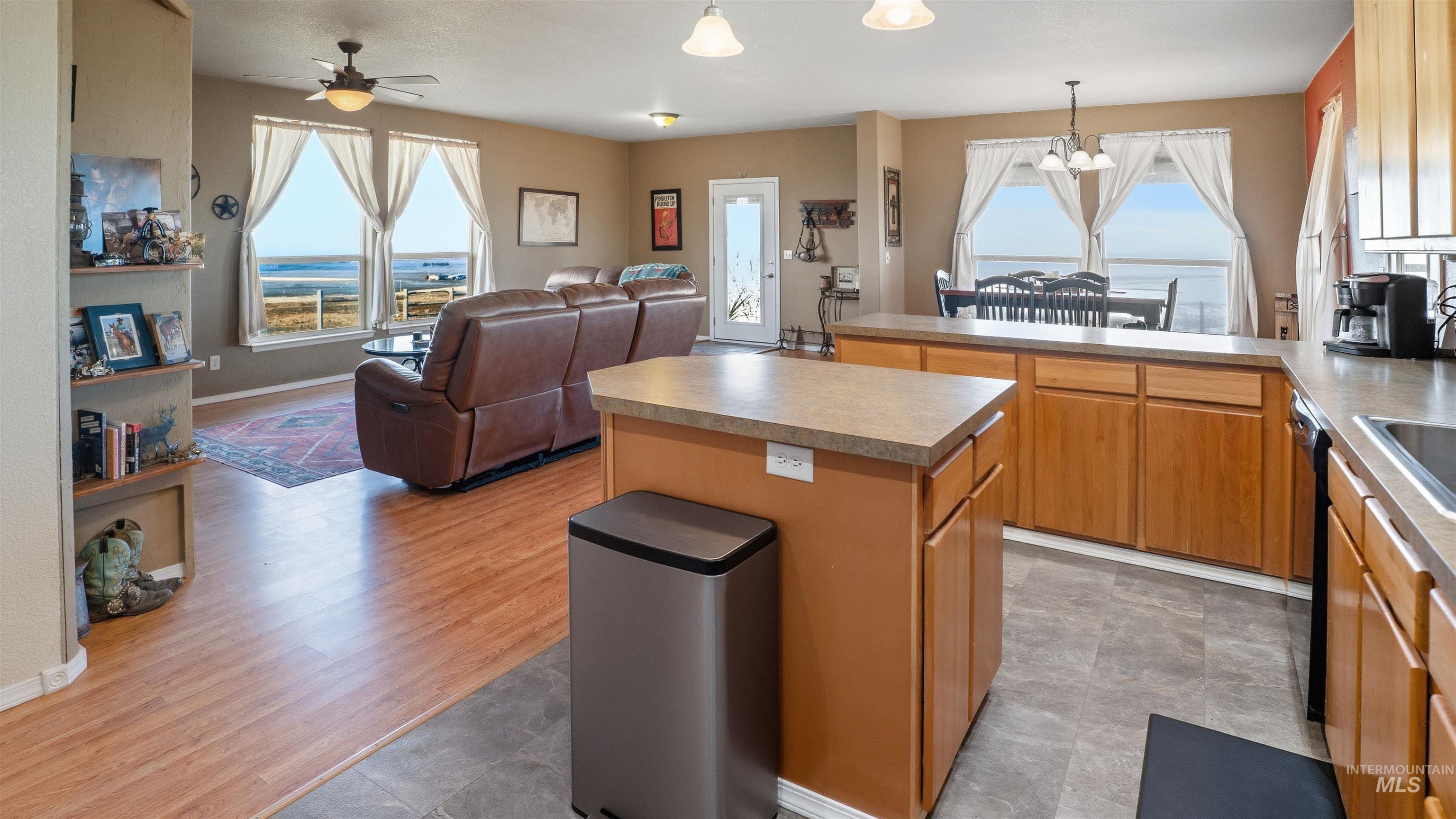 19397 Cloverland Road Asotin, WA 99402 - Photo 36 of 37 Kitchen featuring hanging lights, open floor plan, a kitchen island, and plenty of natural light