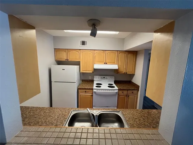 a bathroom with a double vanity sink toilet mirror and bathtub