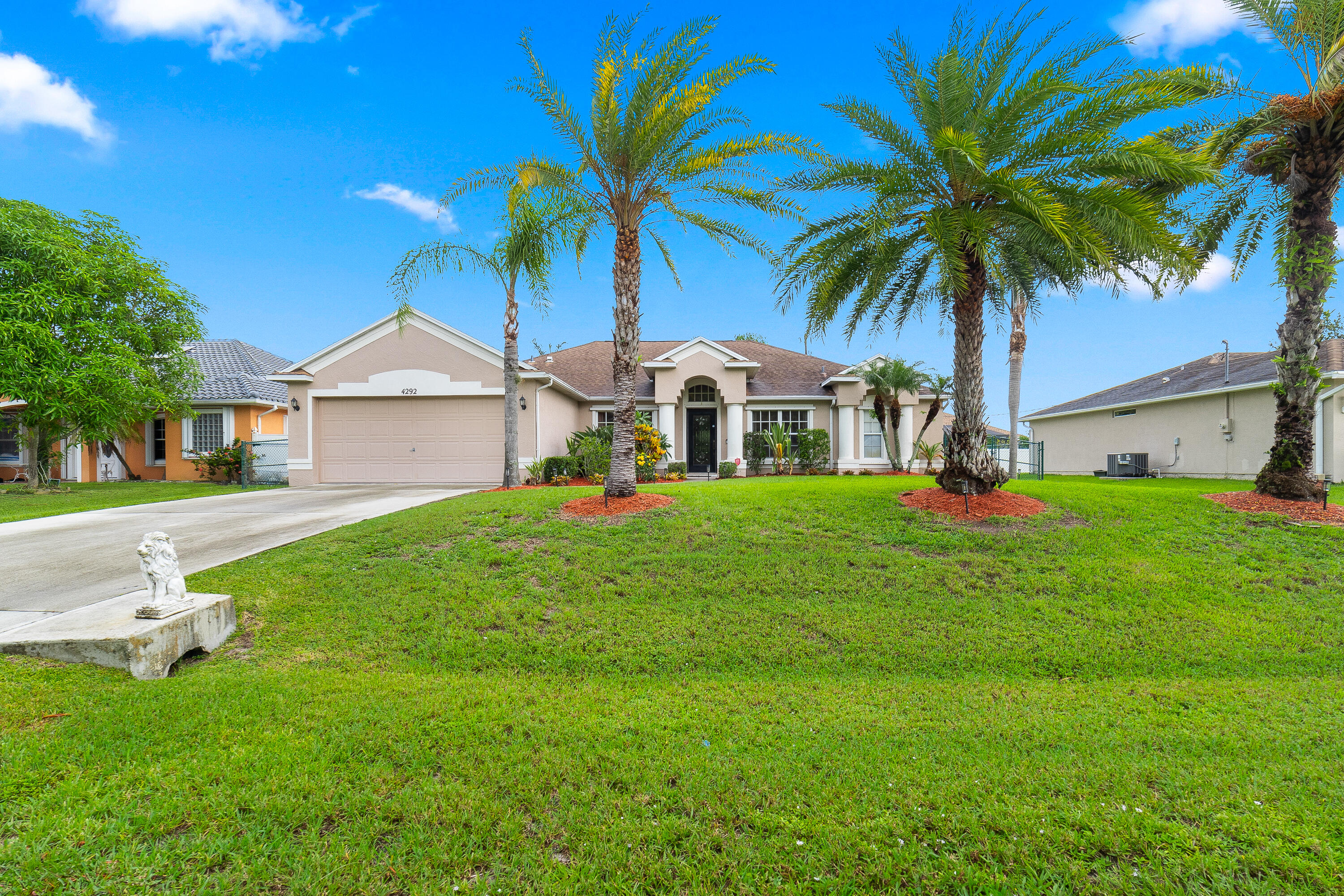a front view of house with yard and green space