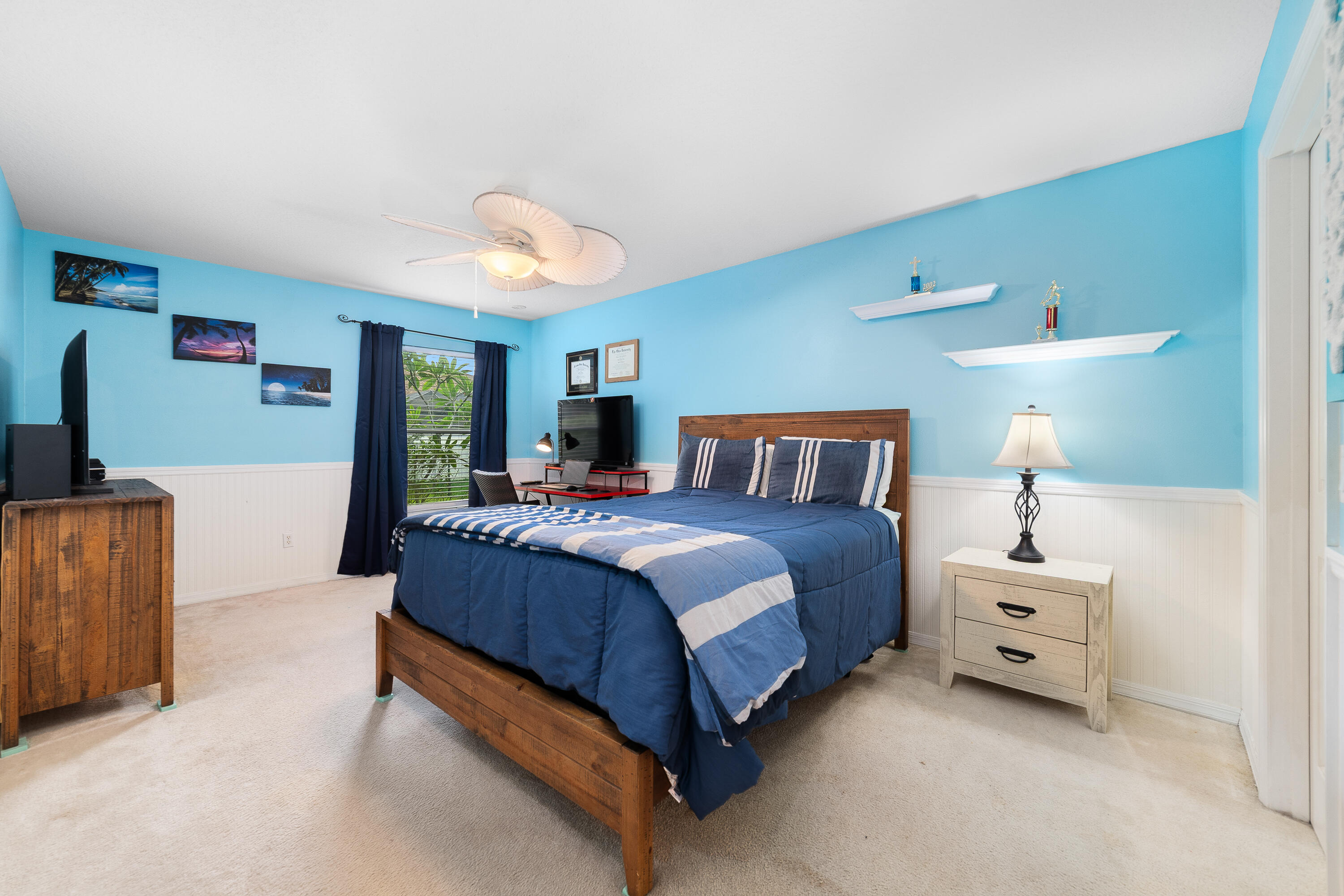 4292 Southwest Whitebread Road Port St. Lucie, FL 34953 - Photo 11 of 28 a spacious bedroom with a bed and a lamp