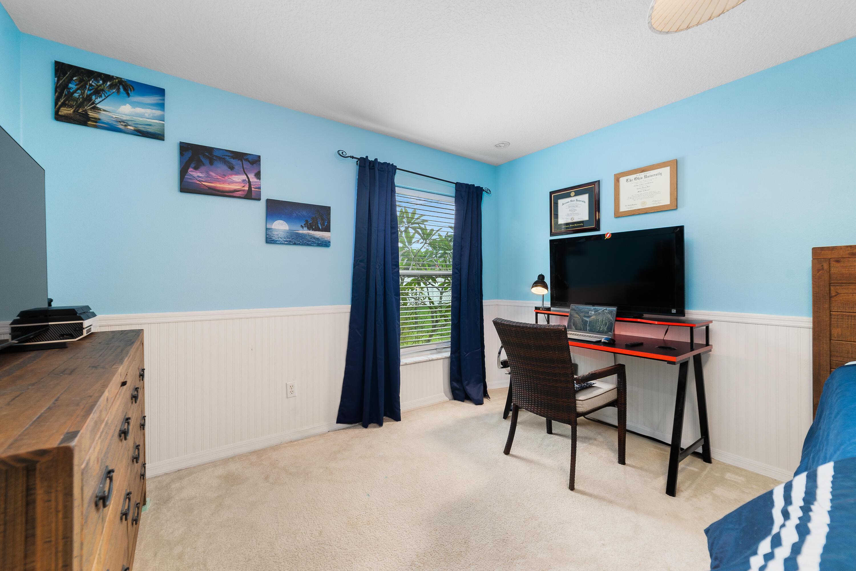 4292 Southwest Whitebread Road Port St. Lucie, FL 34953 - Photo 12 of 28 a view of a livingroom with furniture and a flat screen tv