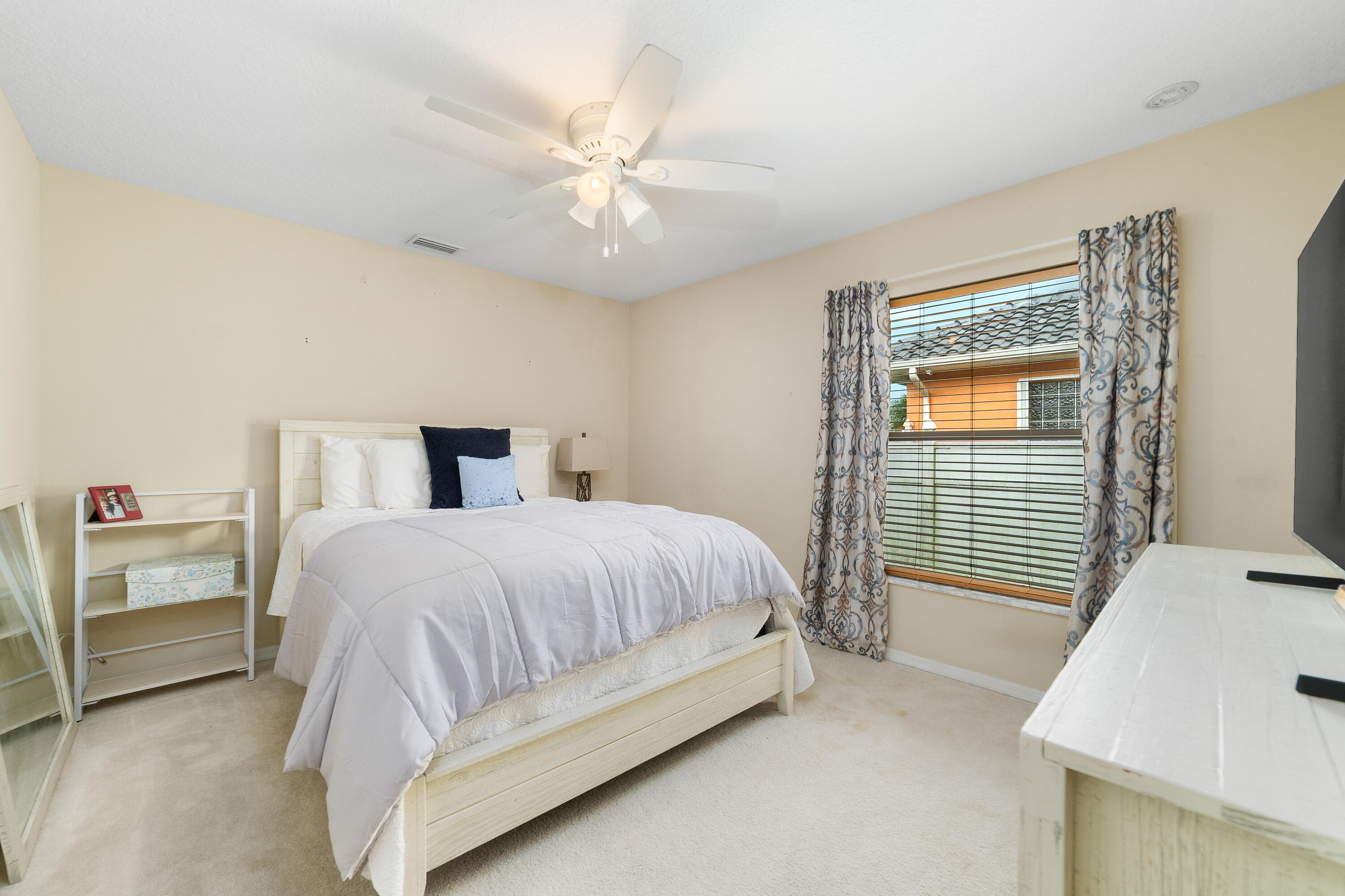 4292 Southwest Whitebread Road Port St. Lucie, FL 34953 - Photo 15 of 28 a bedroom with a bed and a window