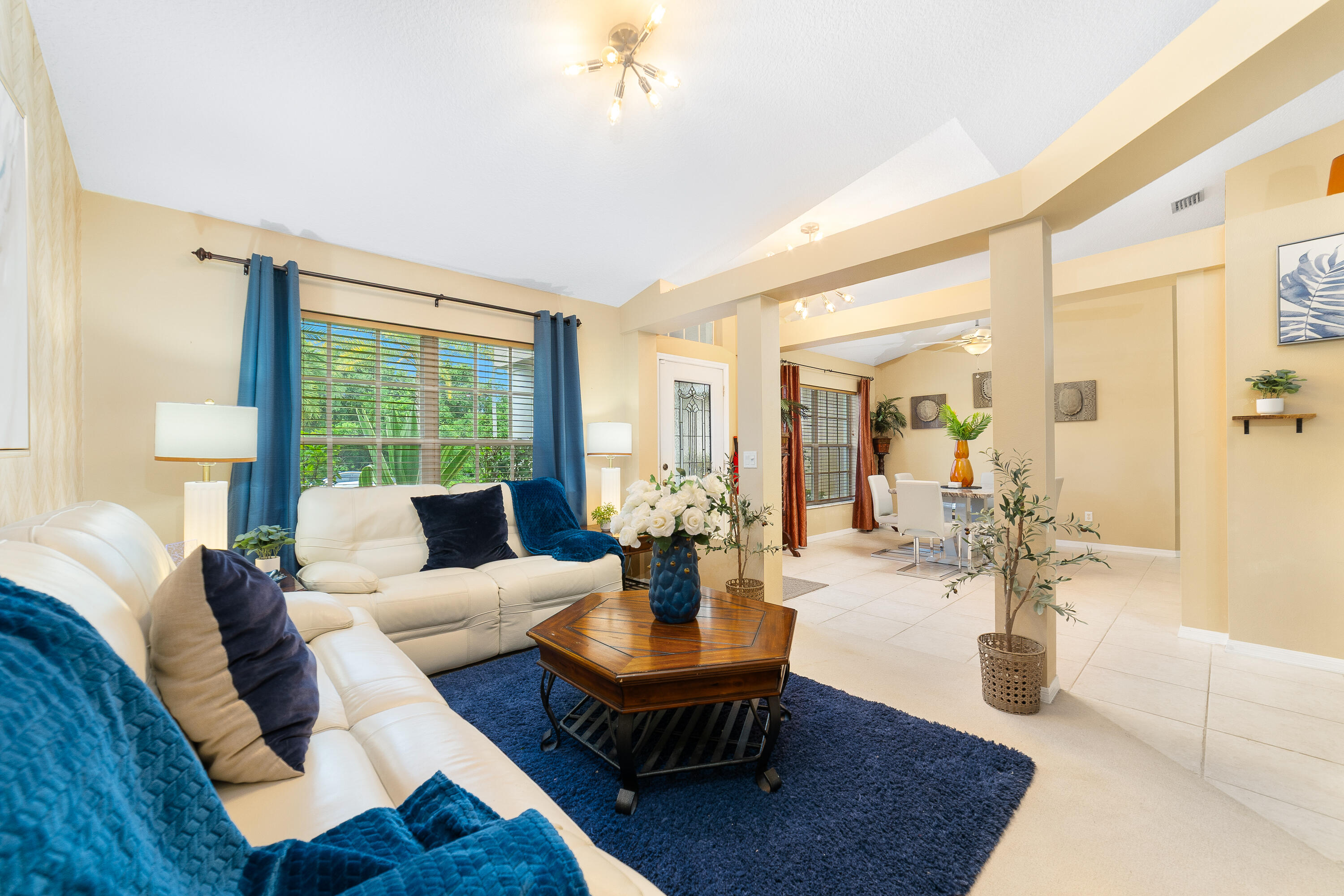 4292 Southwest Whitebread Road Port St. Lucie, FL 34953 - Photo 2 of 28 a living room with fireplace furniture and a large window