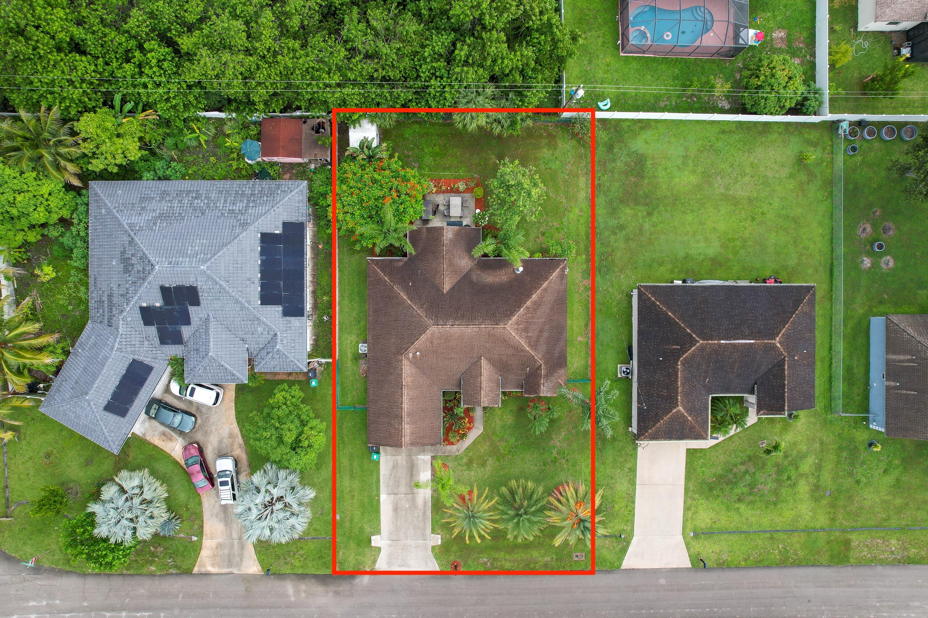 4292 Southwest Whitebread Road Port St. Lucie, FL 34953 - Photo 26 of 28 an aerial view of a house with a garden and outdoor seating