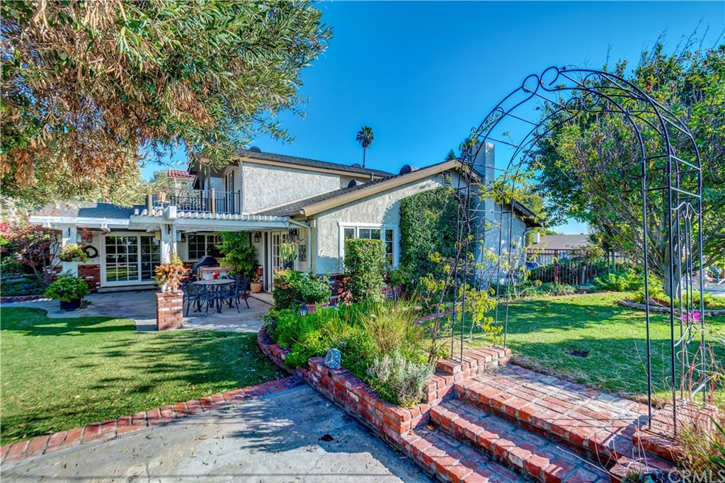 12513 Carinthia Drive Whittier, CA 90601 - Photo 27 of 35 a view of a patio with table and chairs potted plants and large tree