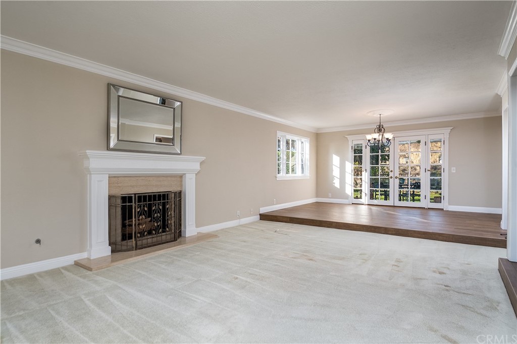 12513 Carinthia Drive Whittier, CA 90601 - Photo 6 of 35 an empty room with fireplace and windows