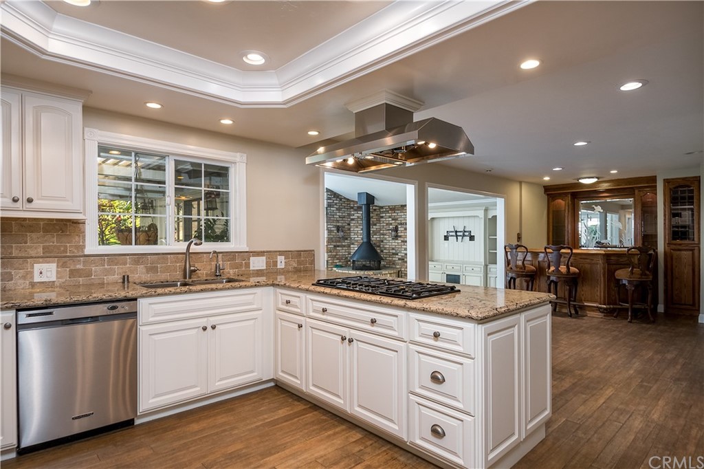 12513 Carinthia Drive Whittier, CA 90601 - Photo 9 of 35 a kitchen with white cabinets and sink
