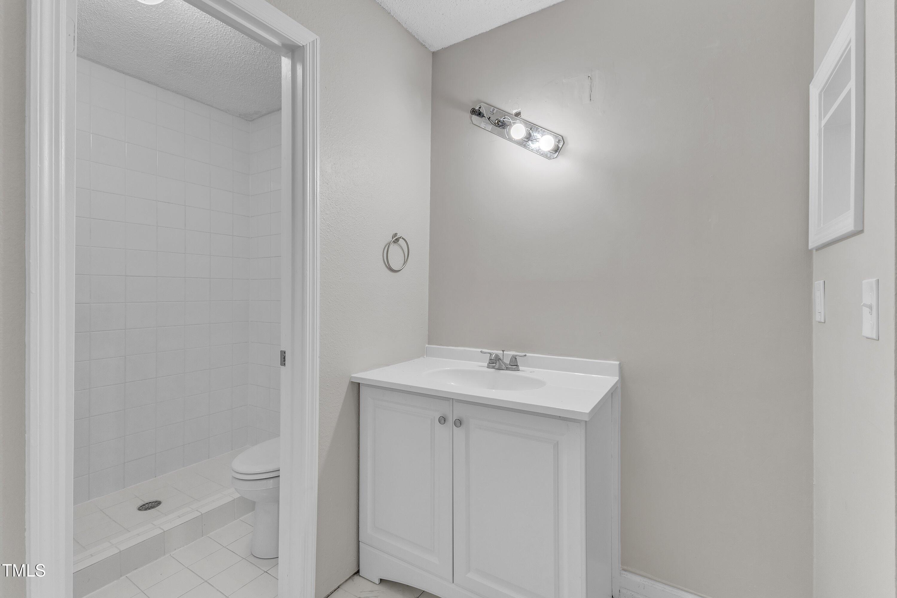 7811 Falcon Rest Circle Raleigh, NC 27615 - Photo 31 of 39 a bathroom with a sink a toilet and shower