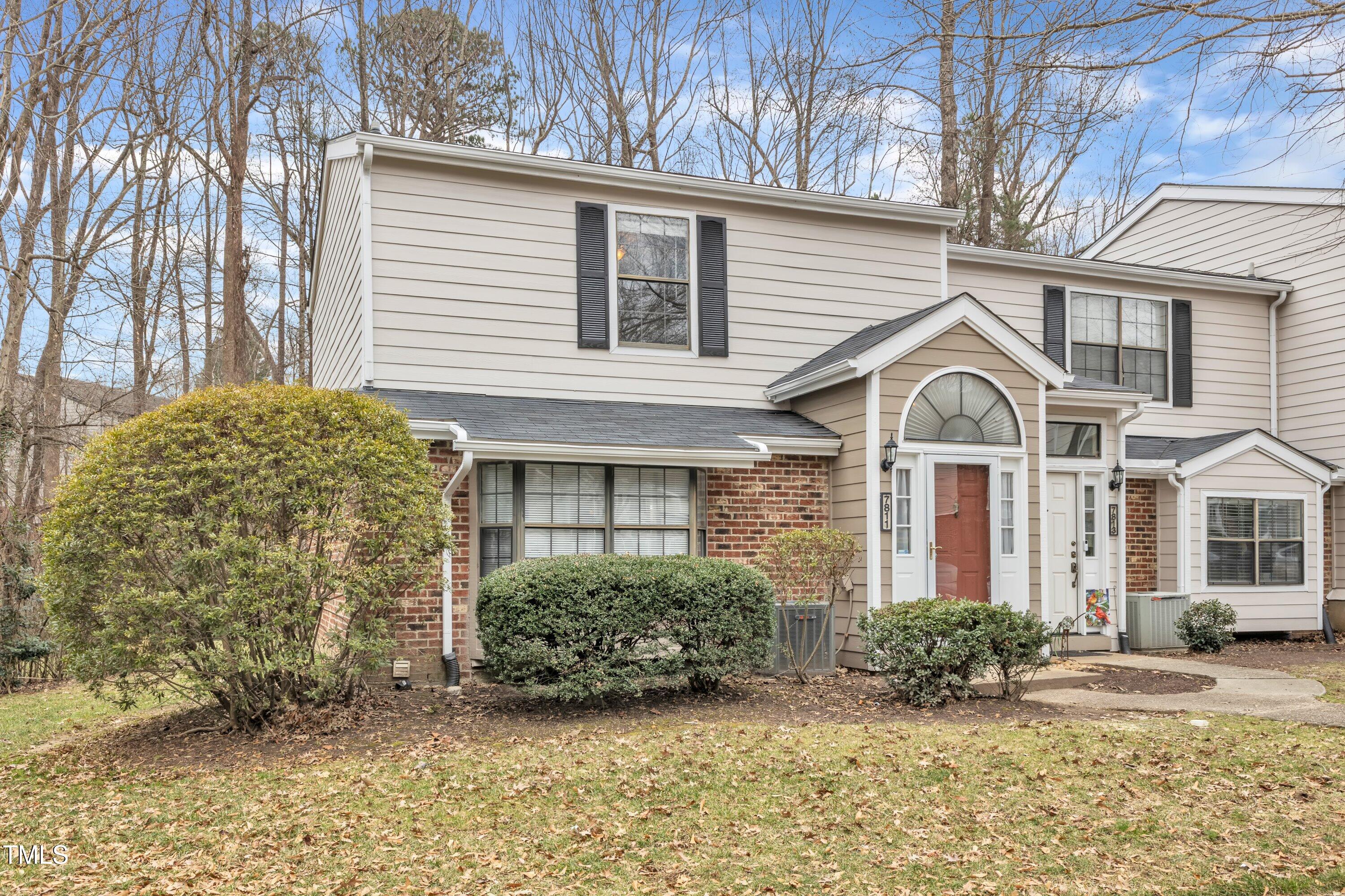 7811 Falcon Rest Circle Raleigh, NC 27615 - Photo 4 of 39 a view of a white house next to a yard with large trees