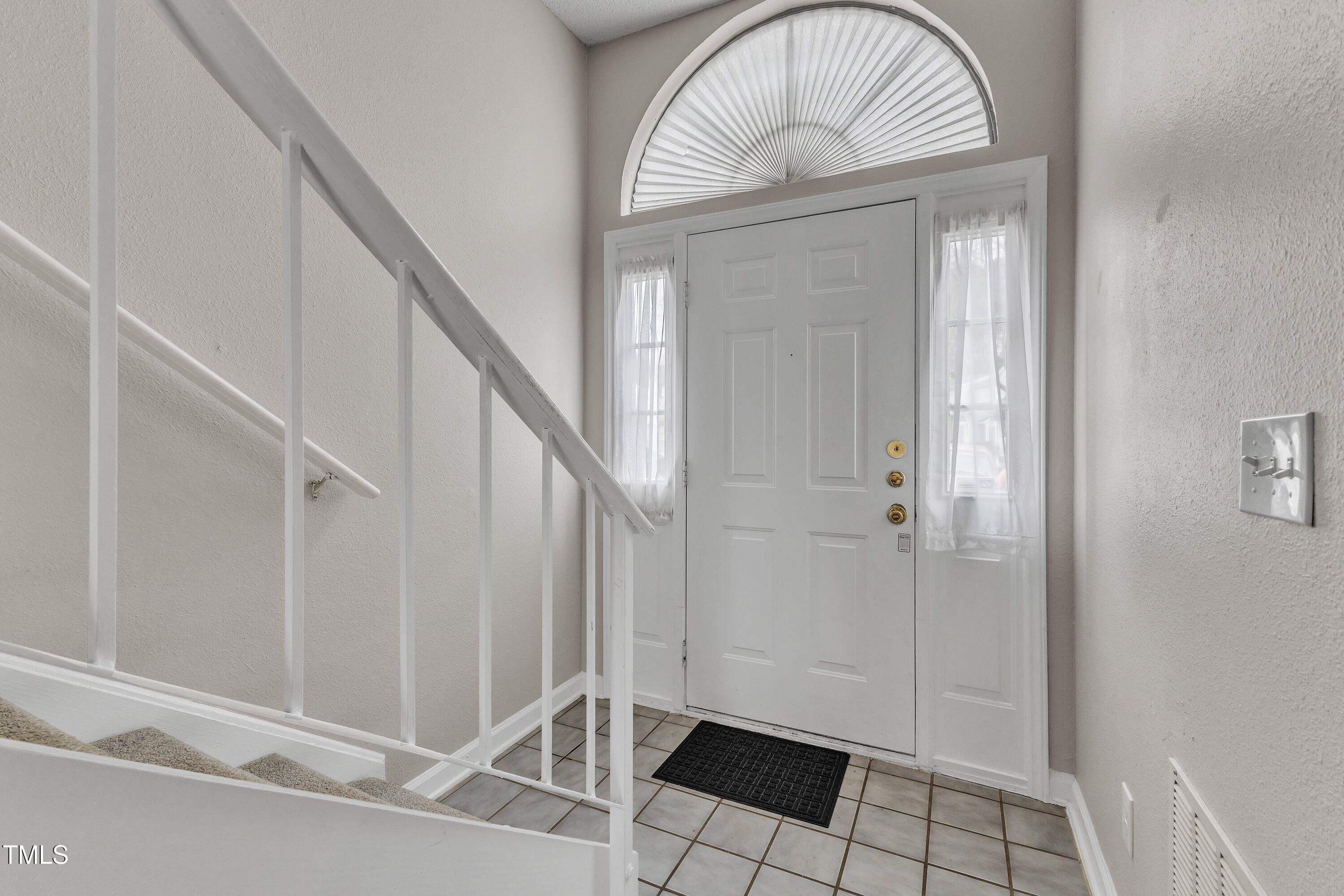 7811 Falcon Rest Circle Raleigh, NC 27615 - Photo 6 of 39 a view of an entryway with wooden floor