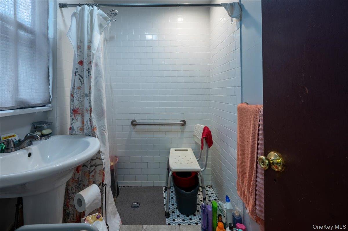 158-24 75th Road Queens, NY 11366 - Photo 5 of 15 Bathroom featuring a shower stall and tile patterned floors