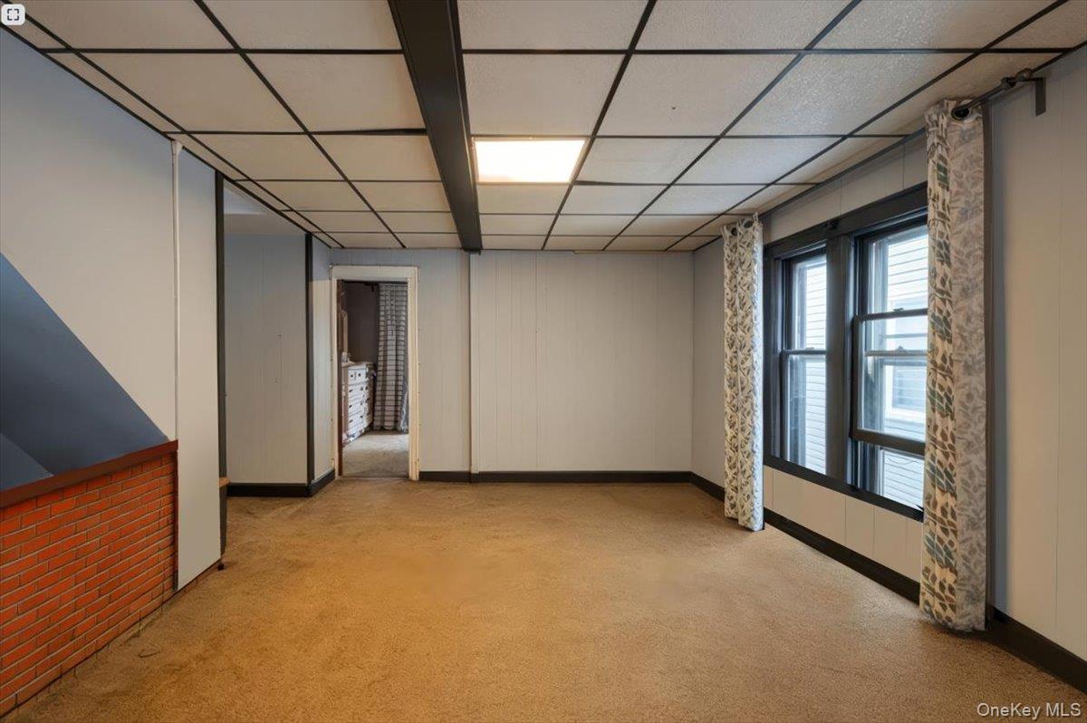 158-24 75th Road Queens, NY 11366 - Photo 10 of 15 Unfurnished room featuring light carpet and a paneled ceiling
