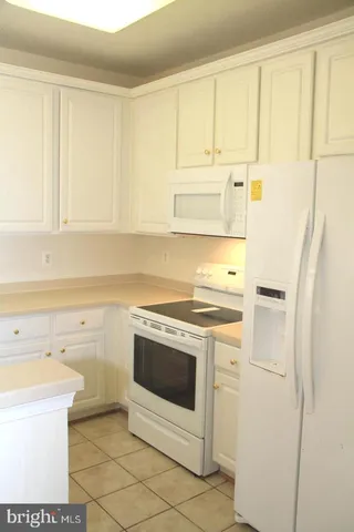 a kitchen with a stove sink and cabinets
