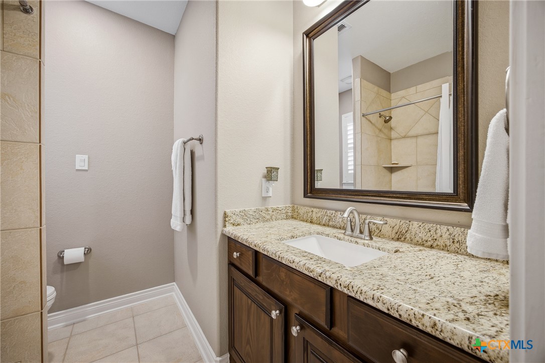 2427 Anderson Point Lane Spring, TX 77388 - Photo 34 of 47 a bathroom with a granite countertop sink and a mirror