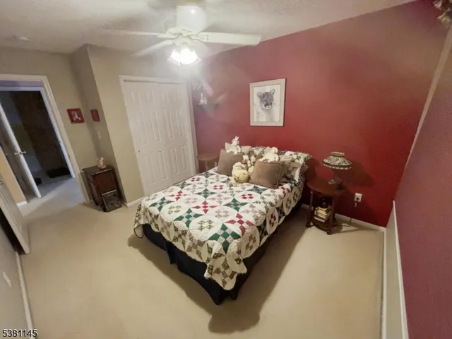 a bed sitting in a bedroom next to a window with pc on the wall