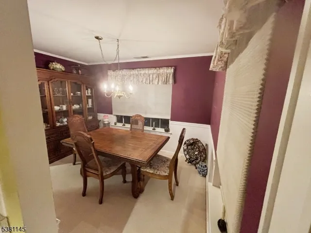 a view of a dining room with furniture and window