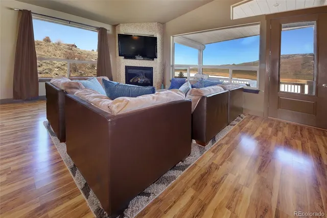 a living room with furniture fireplace and flat screen tv