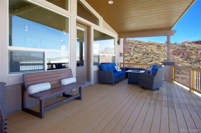 a living room with furniture water view and large windows
