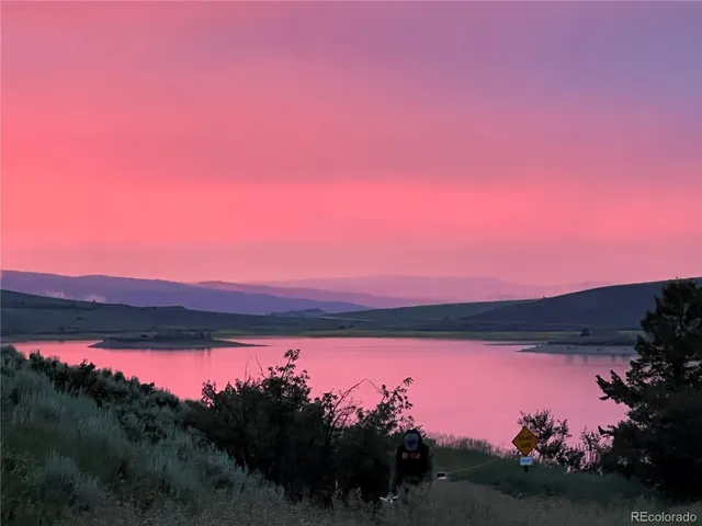 a sunset view with a lake
