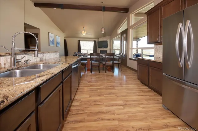 a kitchen with counter top space a sink appliances and cabinets