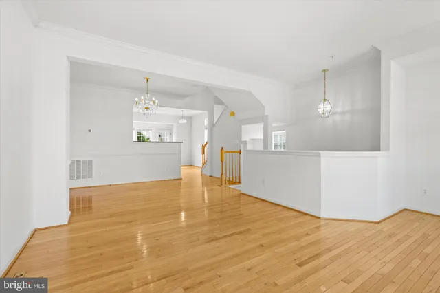 a view of a kitchen with kitchen island an oven and wooden floor