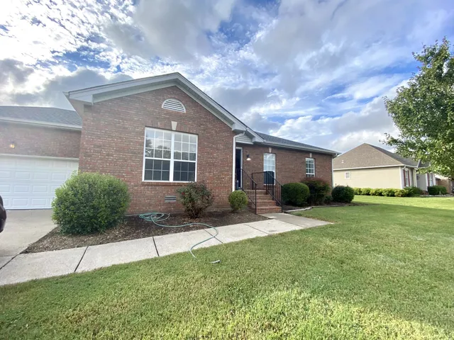 a front view of a house with a yard and porch