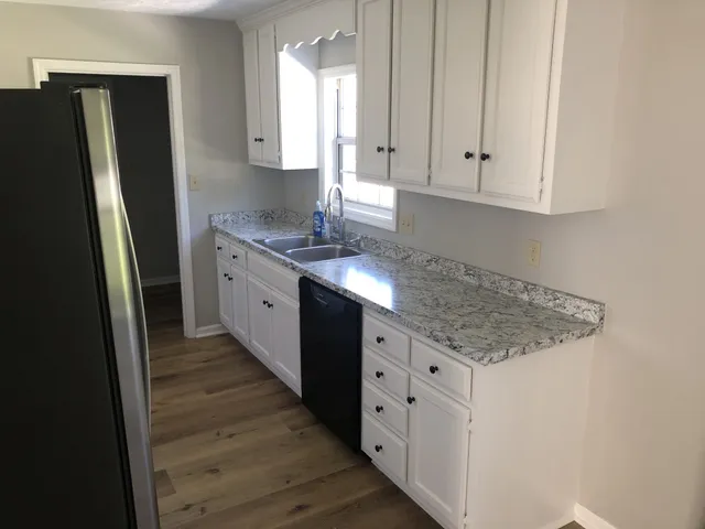 a kitchen with stainless steel appliances granite countertop a refrigerator and a stove