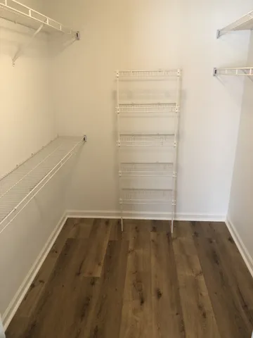 a bathroom with a granite countertop bathtub shower sink vanity and a toilet