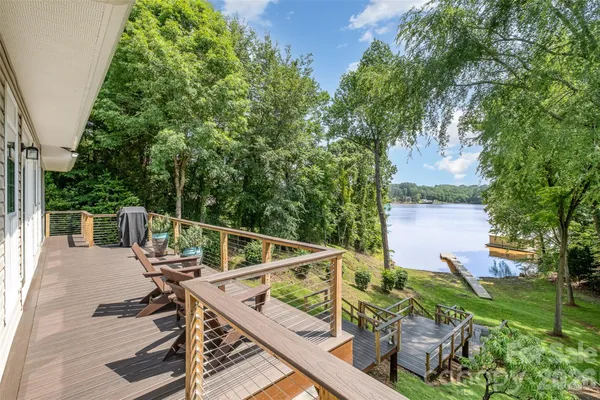 a view of a deck with chairs next to a yard