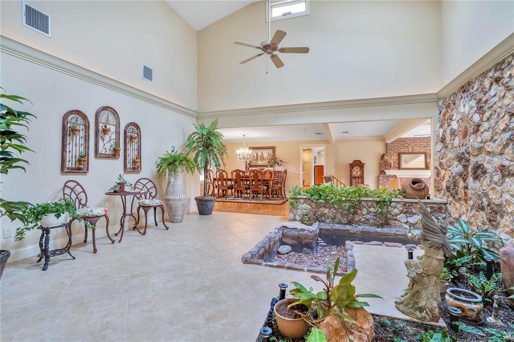 11450 Fangorn Road Orlando, FL 32825 - Photo 12 of 58 a living room with furniture and a chandelier