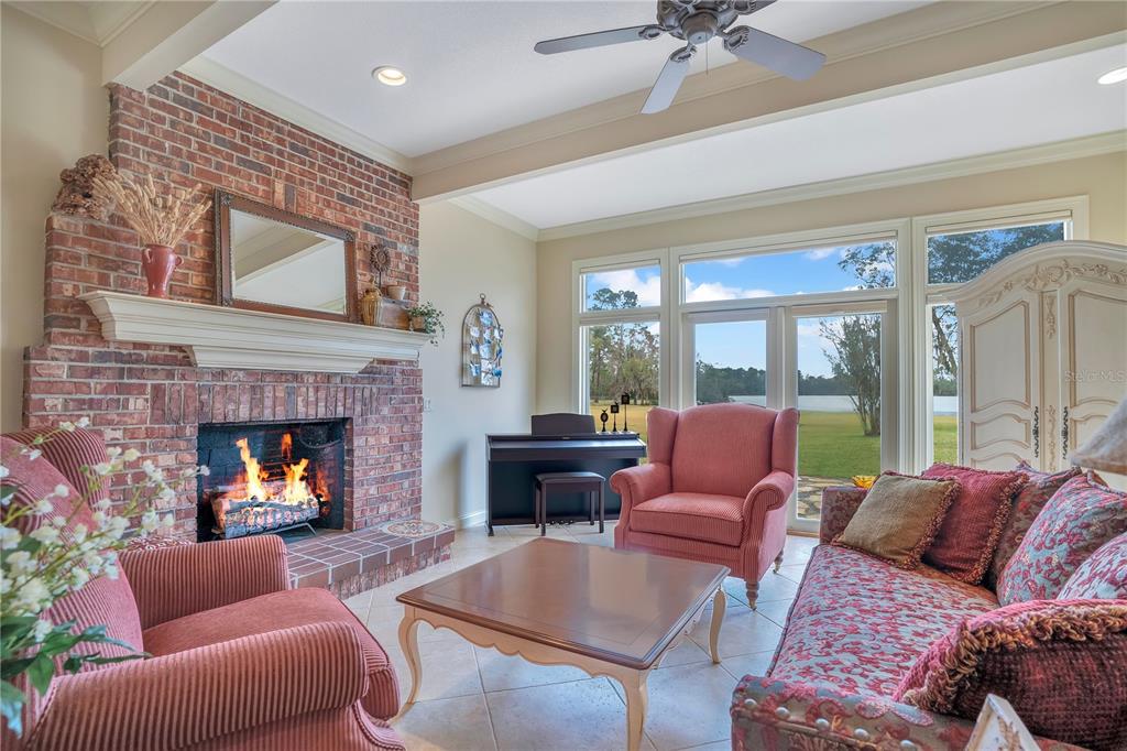 11450 Fangorn Road Orlando, FL 32825 - Photo 15 of 58 a living room with furniture fireplace and a large window