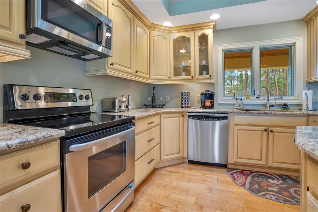 11450 Fangorn Road Orlando, FL 32825 - Photo 22 of 58 a kitchen with stainless steel appliances granite countertop a sink stove and cabinets