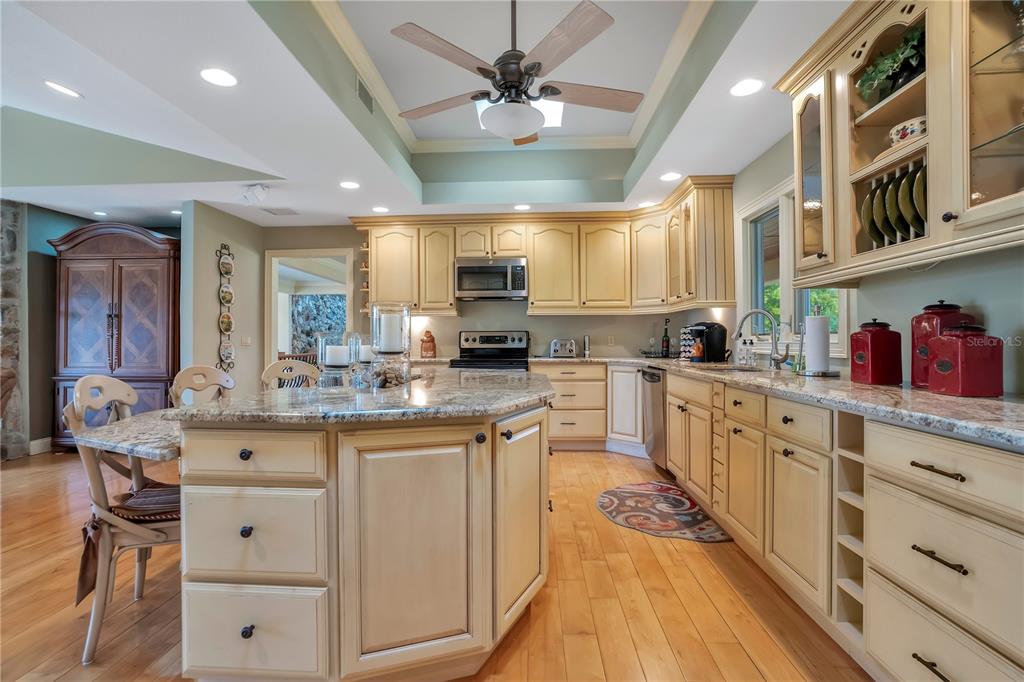 11450 Fangorn Road Orlando, FL 32825 - Photo 23 of 58 a kitchen with stainless steel appliances granite countertop a sink and cabinets