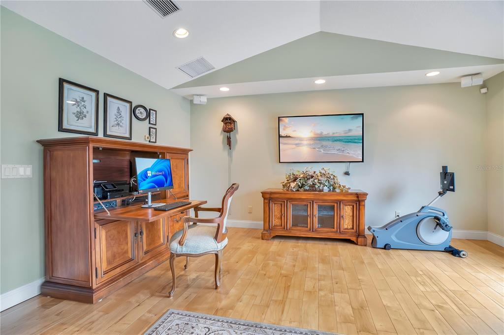 11450 Fangorn Road Orlando, FL 32825 - Photo 27 of 58 a living room with furniture a flat screen tv and gym equipment