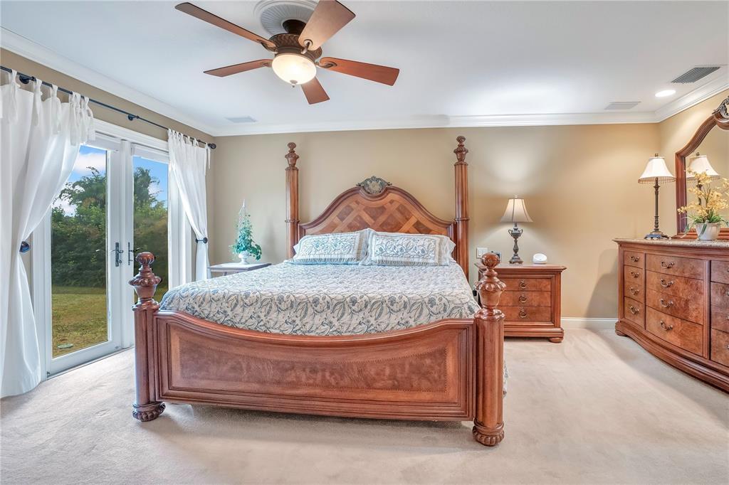 11450 Fangorn Road Orlando, FL 32825 - Photo 30 of 58 a bedroom with a bed and a chandelier