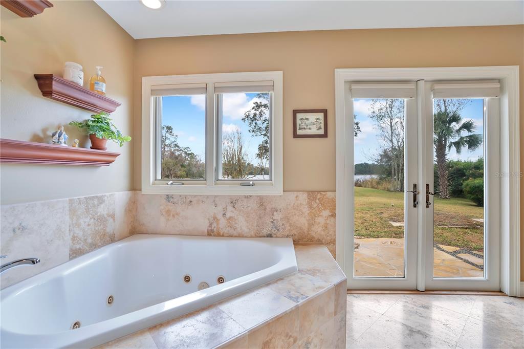 11450 Fangorn Road Orlando, FL 32825 - Photo 33 of 58 a bathroom with a bathtub and a shower