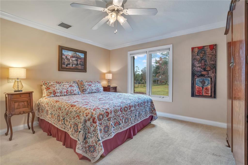 11450 Fangorn Road Orlando, FL 32825 - Photo 37 of 58 a bedroom with a bed and a chandelier